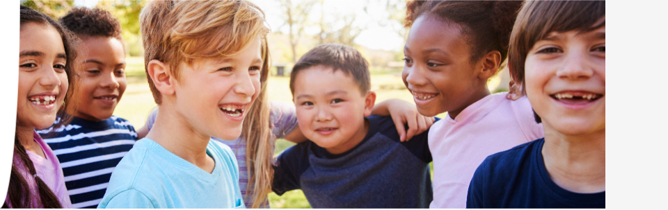 A group of children smiling together outdoors